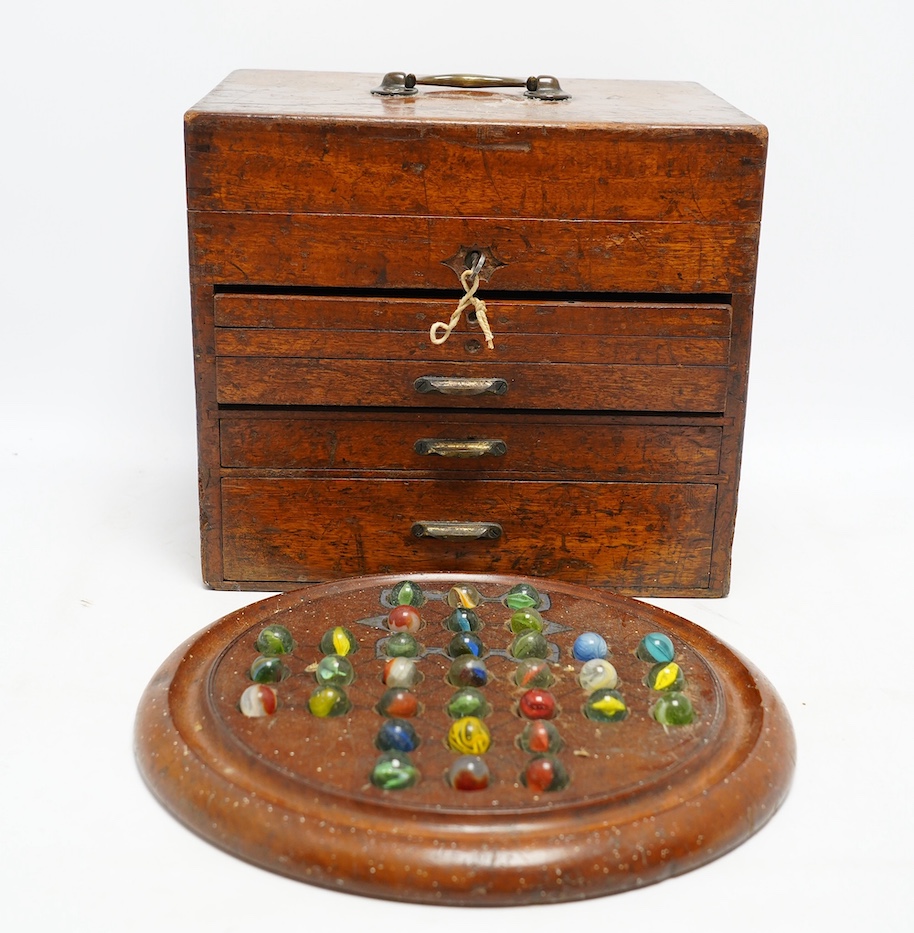 A Victorian circular mahogany solitaire board, 30cm diameter, together with a Victorian mahogany instrument box, 26cm high. Condition - fair